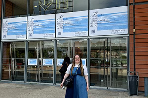 Graduate student April Riddle stands in front of the Centre de Congrès de Lyon