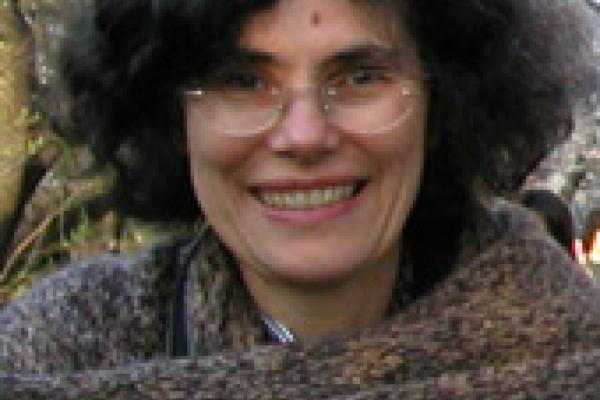 Julia Andrews smiling wearing glasses and a wool scarf