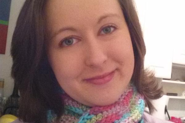 Rebecca Howard wearing a pink top and rainbow scarf
