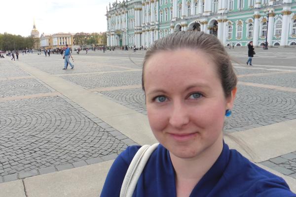Rebecca Howard standing in front of a teal building in Italy