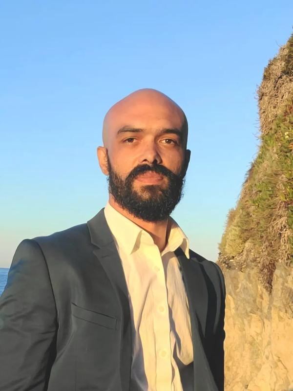 Benjamin L. Jones with ocean and cliff in background