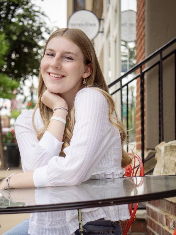 Sophie Machale wearing white shirt and sitting at table
