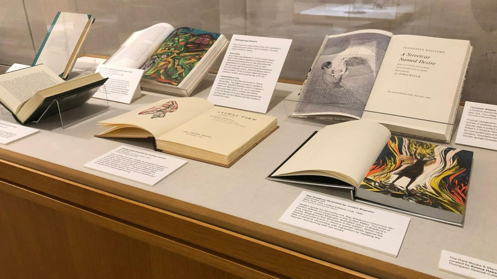 Rare books on display in cabinet with labels