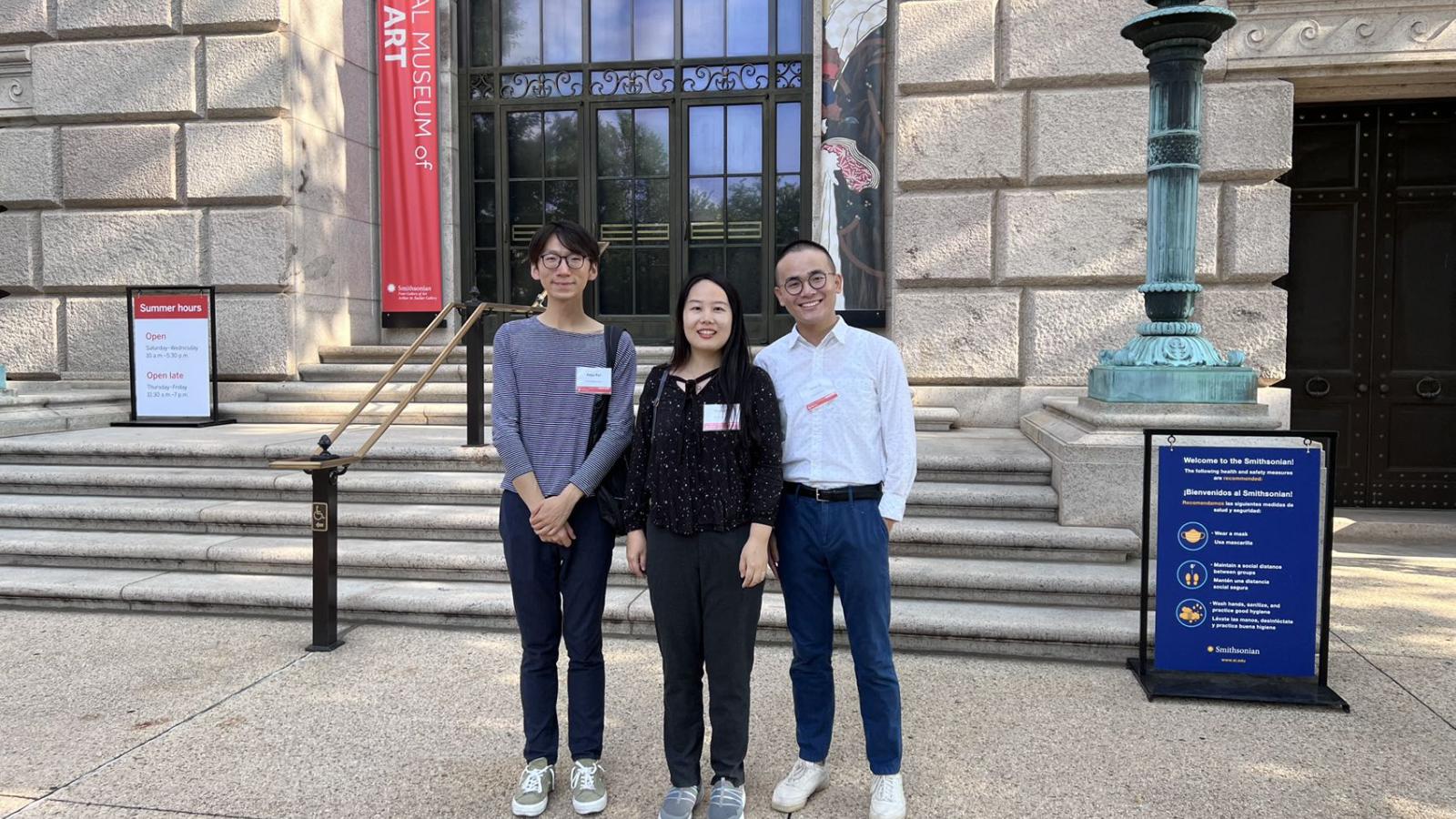 Image of  graduate students Yifan Li and Keyu Yan and PhD Alumna Effie Yin standing in front of the National Museum of Asian Art. 