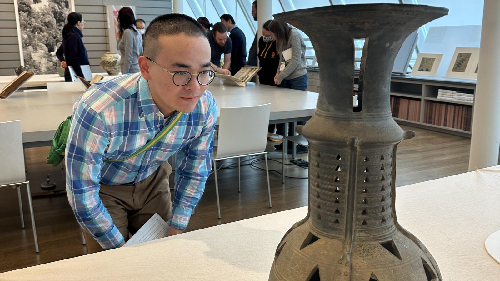 Yifan Li viewing artwork