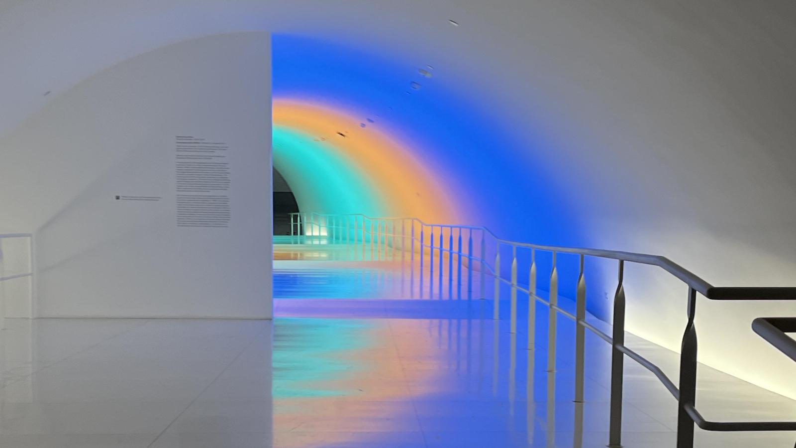 tunnel with green, orange, and blue lights