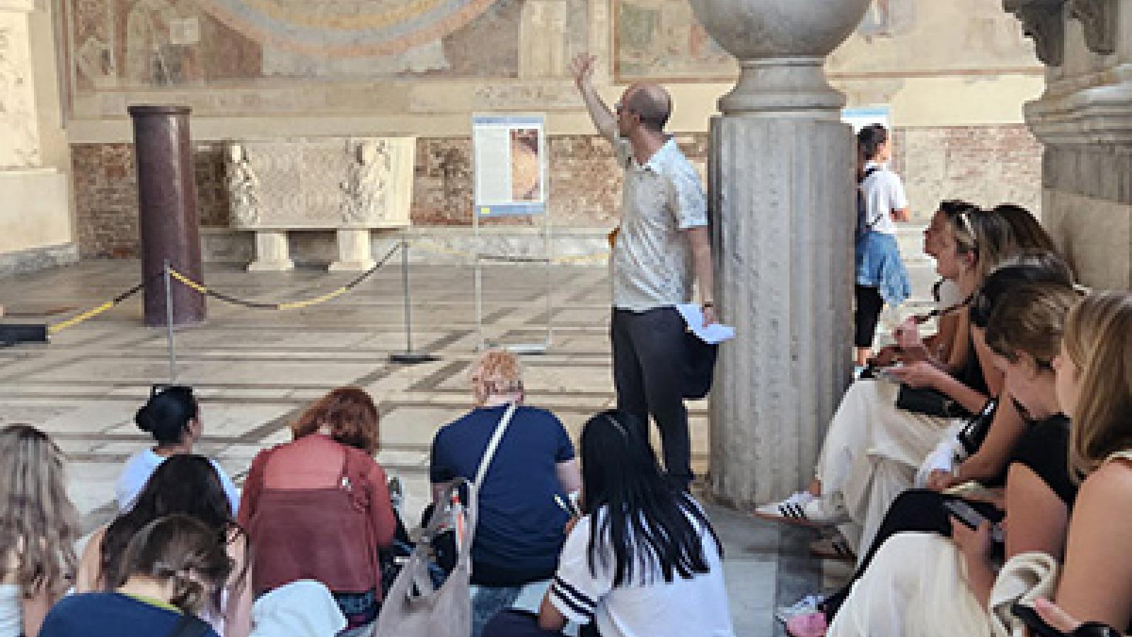 Seated students listen as Professor Whittington speaks during "Medieval Art in Italy"