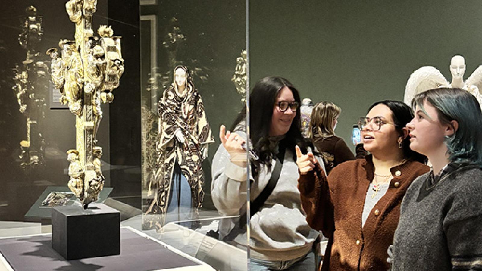 Students observe an art piece. 