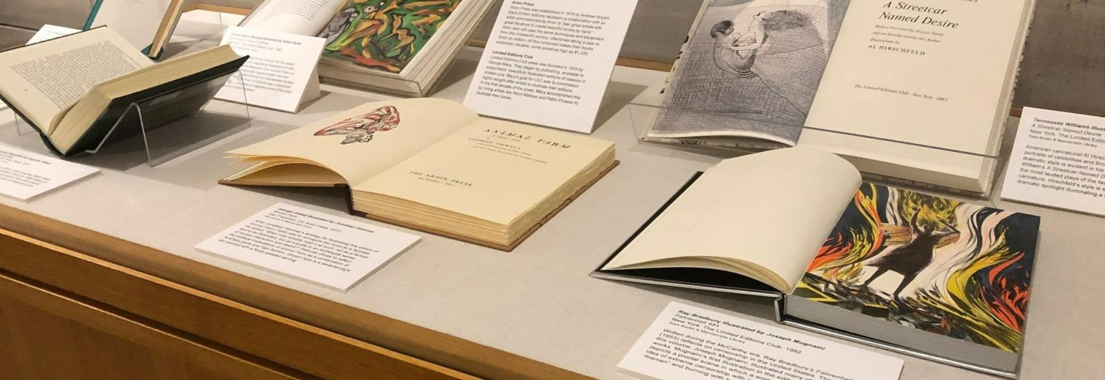 Rare books on display in cabinet with labels