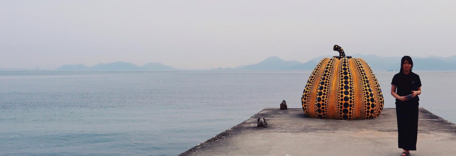 Alice Phan with Yayoi Kusama pumpkin sculpture