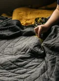 A person sewing a quilt.